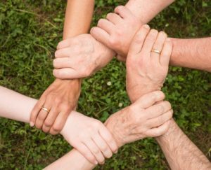 family holding hands in star shap