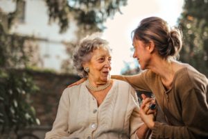 elderly woman hugging daughter discussing investment accounts