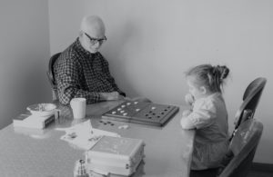 grandpa playing a game with granddaughter thinking about beneficiaries